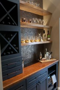 Dark bar with tile backsplash, floating shelves, X-shelf dividers