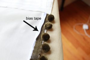 bias tape wrapped around your pom pom trim for a more professional finish