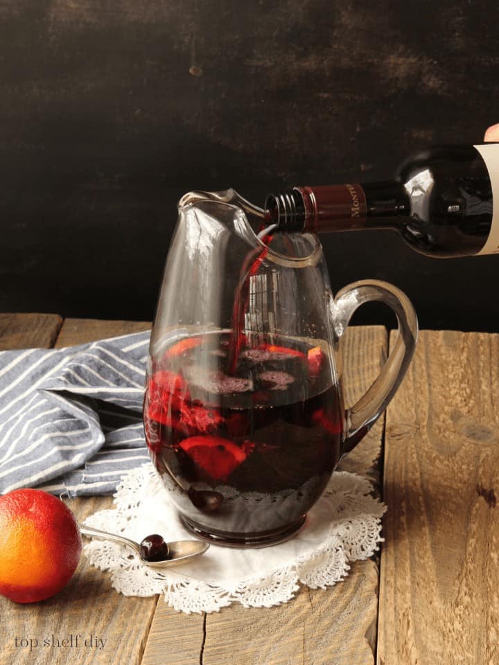 A delicious, dark sangria fit for lords and ladies of The Crown. Featuring Coopers' Smith bourbon and blood orange sangria. Bourbon sangria that combines the flavors of an old-fashioned with a Spanish red wine sangria. #momcocktails #cocktailrecipes #sangriamixture