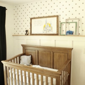How we updated our second baby's room on a budget. Feature wall with board and batten, custom wood sign, stencil wall, and hemmed curtains.