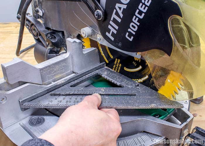 Making sure your miter saw is square prior to cutting crown molding. Image credit: sawsonskates.com