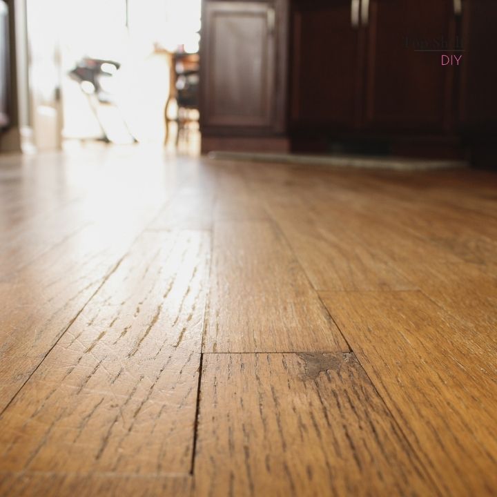 How to fill large cracks and holes in hardwood floors with epoxy wood filler. Here are some tips for maintaining and refinishing hardwood floors that can stand up to years of wear and tear. #hardwoodfloors #diytipsandtricks